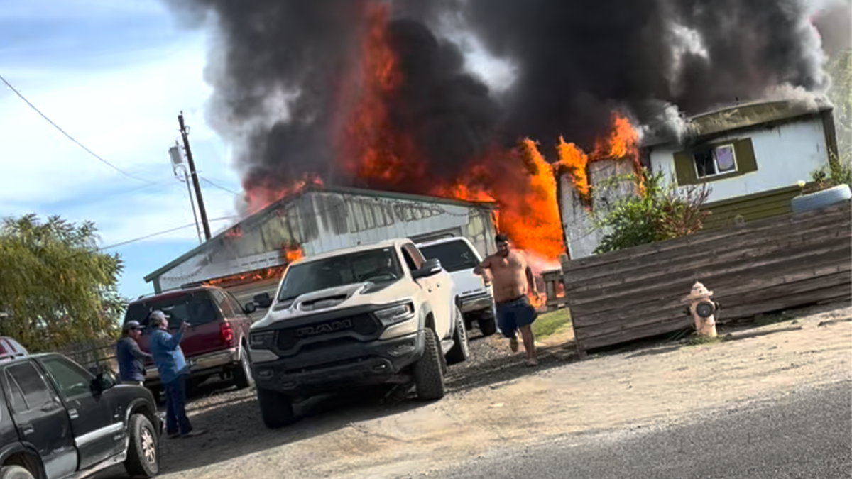 Farmer pulling truck from fire