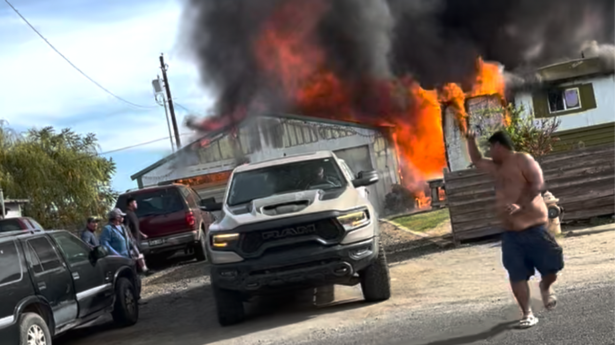 Truck pulling car from fire