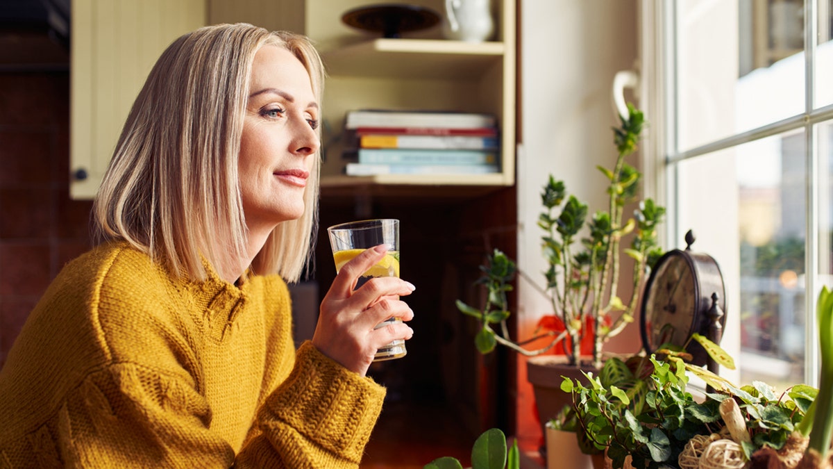 woman drinking lemon water