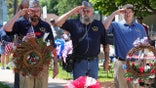 DANVILLE, PENNSYLVANIA, UNITED STATES - 2022/05/30: Members of American Legion Post 40 salute after placing a wreath during the annual Memorial Day service at Memorial Park. Community organizations and military veterans take part in the annual Memorial Day parade and service.
