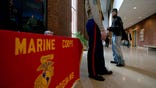 NEW BRUNSWICK, NJ - DECEMBER 1: An undergraduate student listens to US Marine recruiter Staff Sergeant Tim Norris (L) during a Marine recruiting presentation on campus at Rutgers University December 1, 2005 in New Brunswick, New Jersey. The annual Marine quota for officers in the southern half of New Jersey comprising 10 campuses is 28 new recruits. The controversy over the war in Iraq has made recruiting for all branches of the US military more difficult. Some US high schools and universities have barred military recruiters from entering their schools and campuses. Schools that receive public funds are required under the Solomon Amendment to permit US military recruiters onto their grounds. The Solomon Amendment, initially pushed by the Pentagon, is being challenged in the Supreme Court by a group of law schools claiming the US military services discriminate against gays and should therefore not be allowed on campuses. (Photo by Robert Nickelsberg/Getty Images)