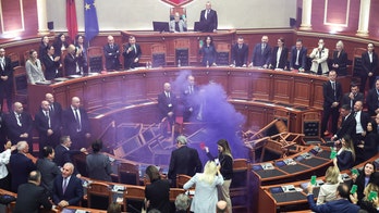 Albanian opposition lawmakers throw firecrackers, disrupt Parliament in protest of socialist governance