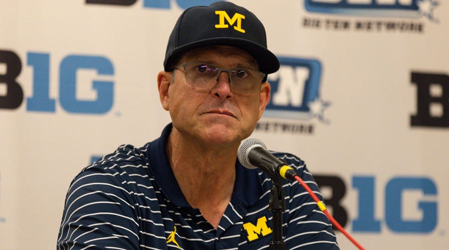 Michigan’s Jim Harbaugh will be credited for wins despite being banned from sidelines: report