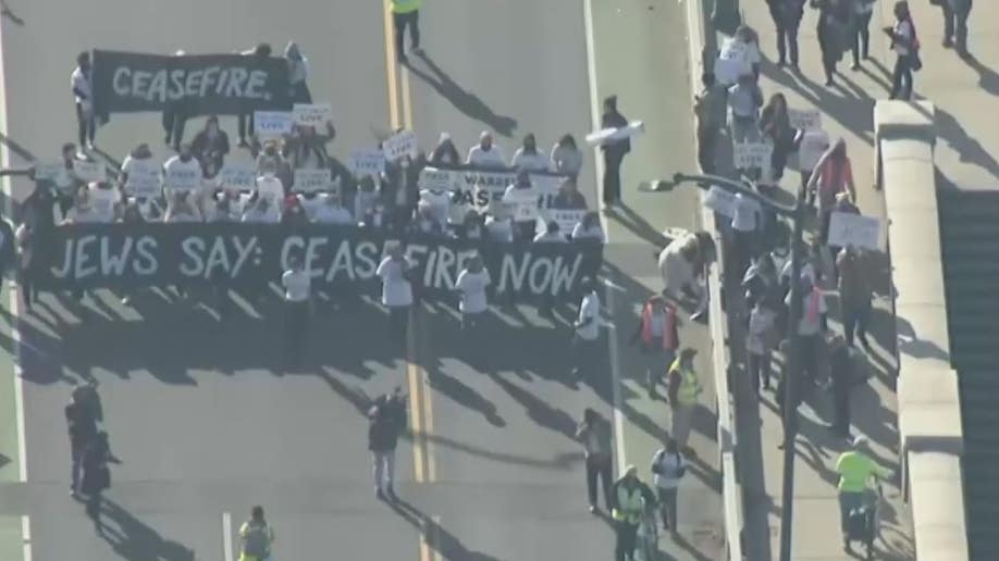 protesters marching across bridge