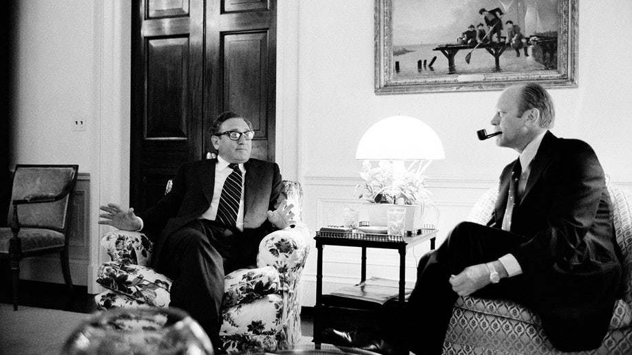 Secretary of State Henry Kissinger and President Gerald Ford talk in the White House