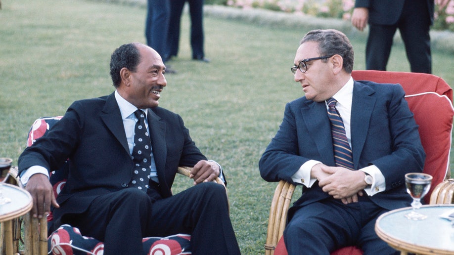 Egyptian President Anwar Sadat and U.S. Secretary of State Henry Kissinger talk during the Sinai II negotiations