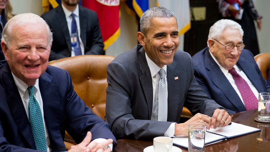Barack Obama smiles alongside Henry Kissinger