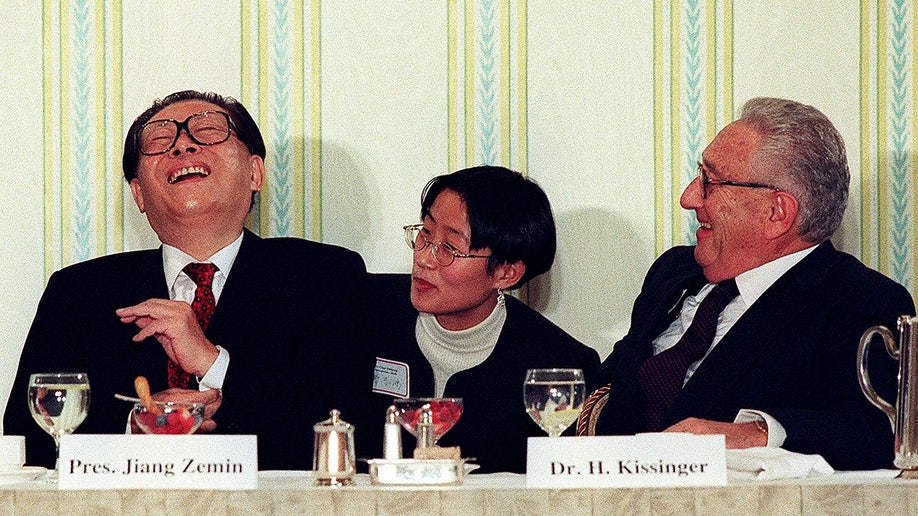 Henry Kissinger laughs with Chinese President Jiang Zemin