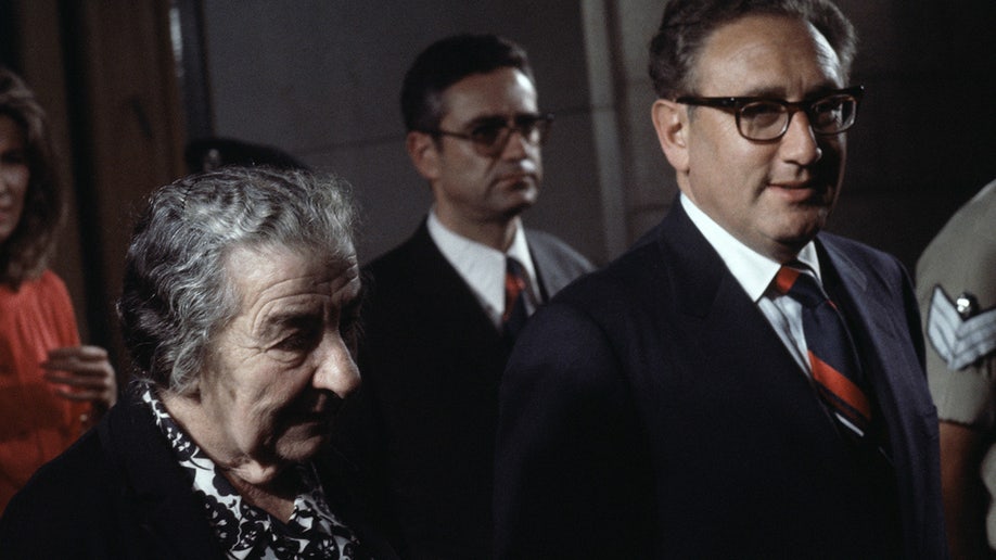 Golda Meir alongside Henry Kissinger