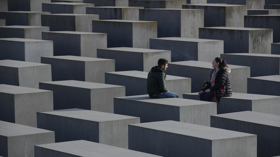 People sitting at Holocaust Memorial