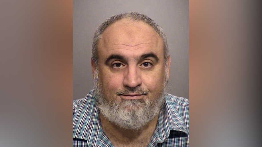 Loay Alnaji seen in a booking picture emotionless