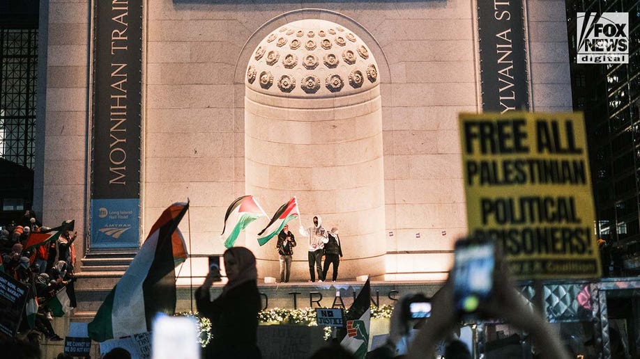 Pro-Palestine protestors gather outside of the Moynihan Train Hall in Midtown Manhattan
