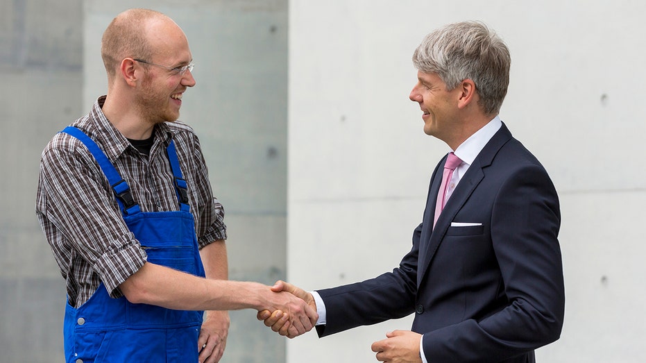 Two workers shake hands