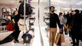Shoppers look at clothes while others walk around Twelve Oaks Mall on Nov. 24, 2023, in Novi, Michigan.