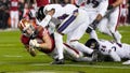 Christian McCaffrey #23 of the San Francisco 49ers dives past Marlon Humphrey #44 of the Baltimore Ravens while scoring a rushing touchdown during the second quarter at Levi's Stadium on December 25, 2023 in Santa Clara, California.