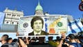 A supporter holds a giant dollar bill with the face President elect Javier Milei as people start gathering outside National Congress ahead of his inauguration ceremony on Dec. 10, 2023 in Buenos Aires, Argentina.