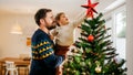Father is lifting his son to put the star on the Christmas tree. Both are wearing winter sweaters. They are cheerful and smiling. Horizontal photo. Bright and cozy living room. - Fox News