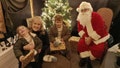 Emily Andrews, Tanya Andrews and Hugo Andrews with Santa at Airmyn Park Primary School in Goole, East Yorkshire, England, after Emily Andrew was able to tell Santa what she wanted for Christmas.