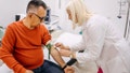 Nurse doing procedure of a blood capture from a vein.