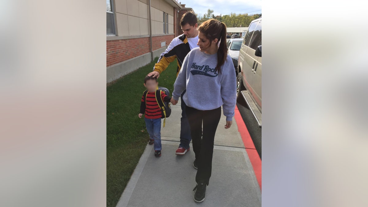 Libby Caswell walks with her son and boyfriend