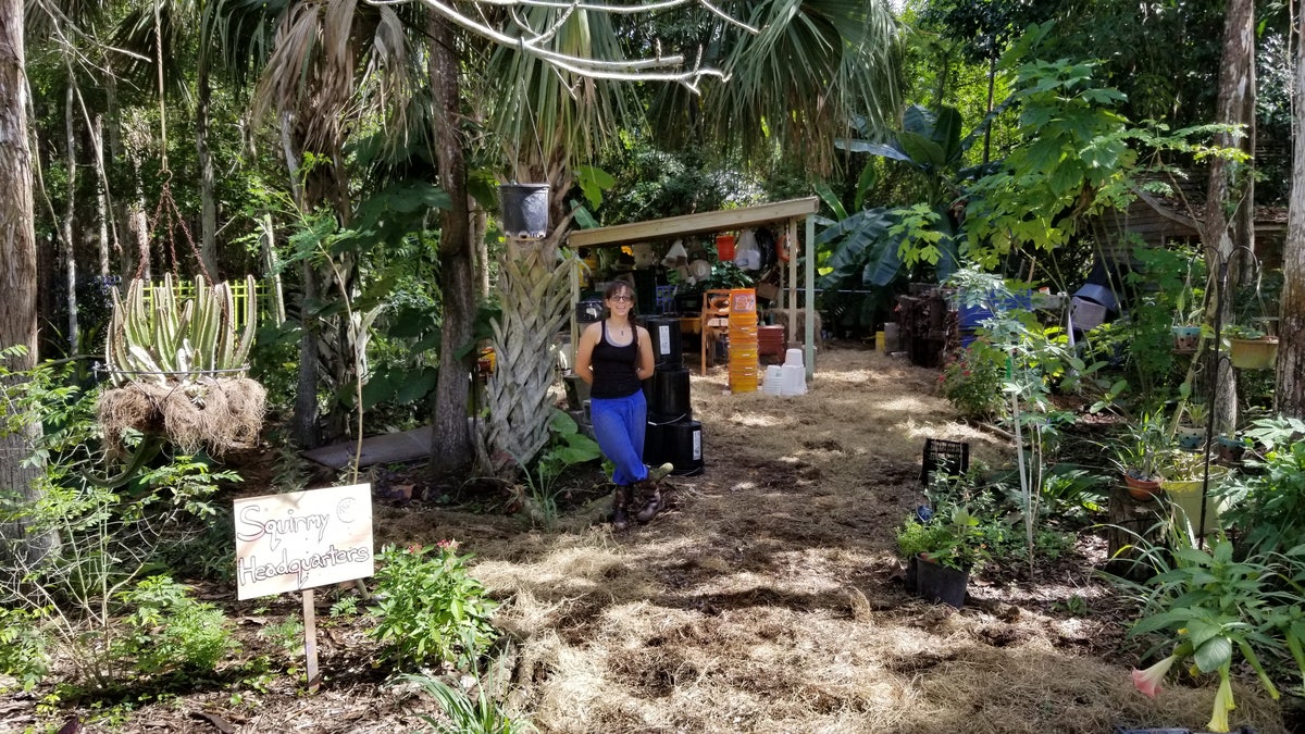 Mel Corichi stands at the entrance of the Let it Rot farm