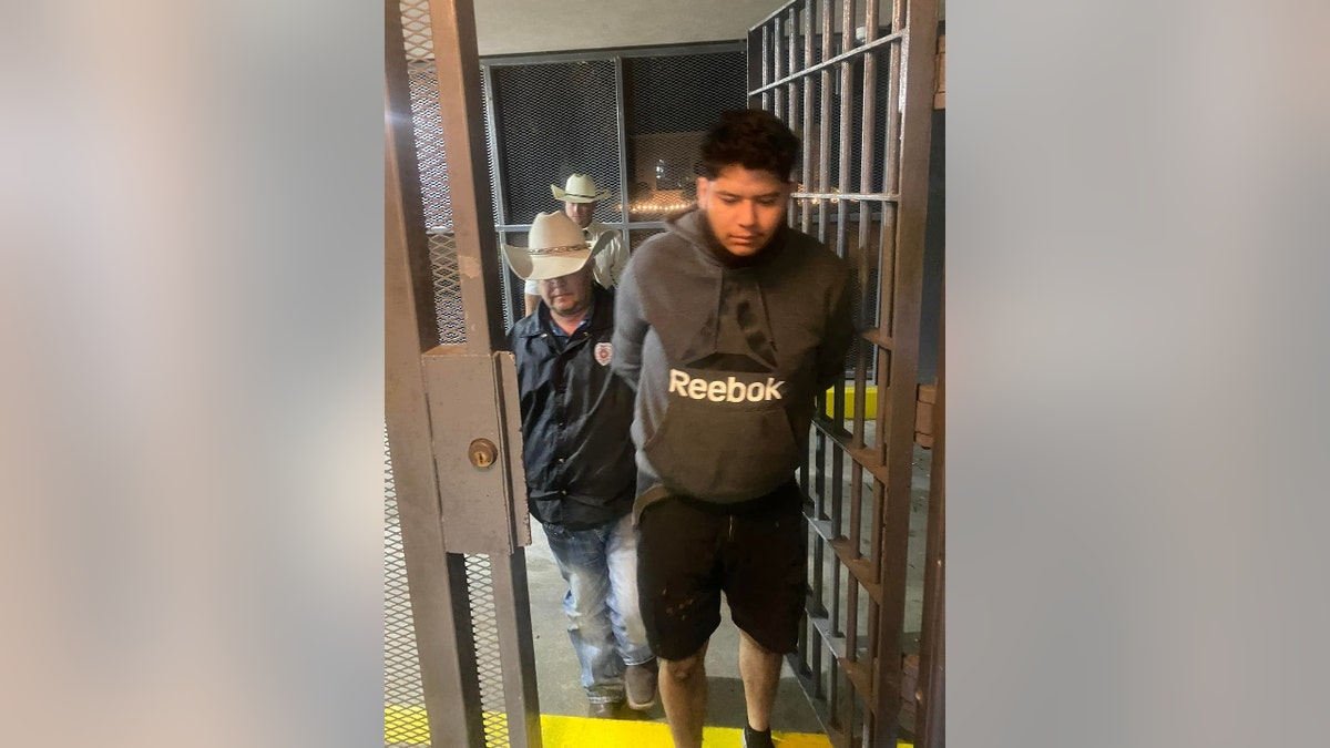 Rafael Romero being taken into custody
