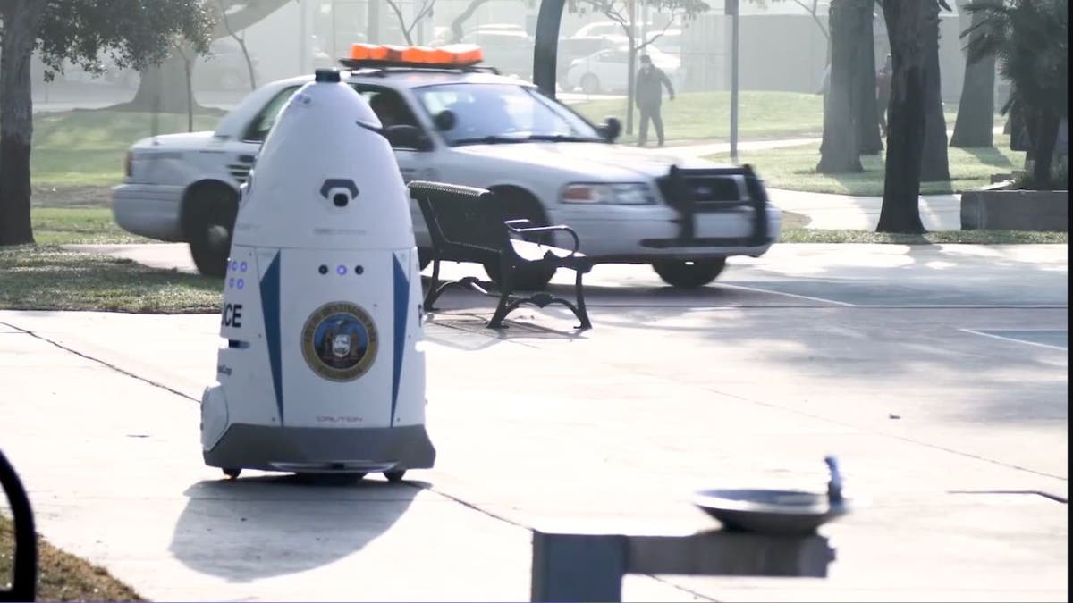 crime-fighting robot near cop car