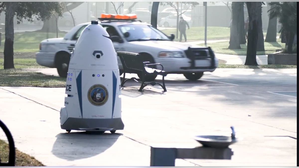 crime-fighting robot near cop car