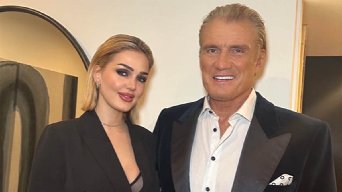 dolph lundgren with wife emma krokdal smiling at black tie event