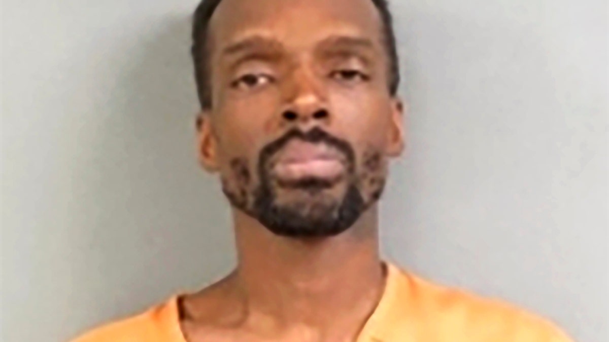 Kierre L. Williams in orange jail smock for mugshot
