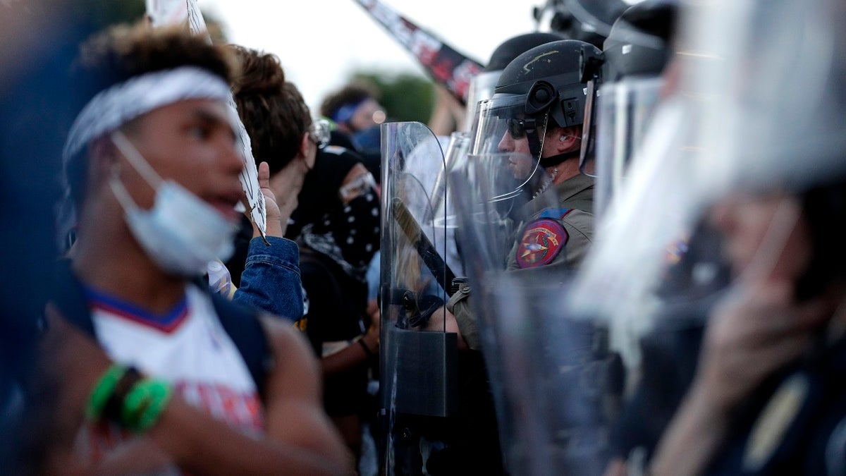 Protesters face off with Austin police officers