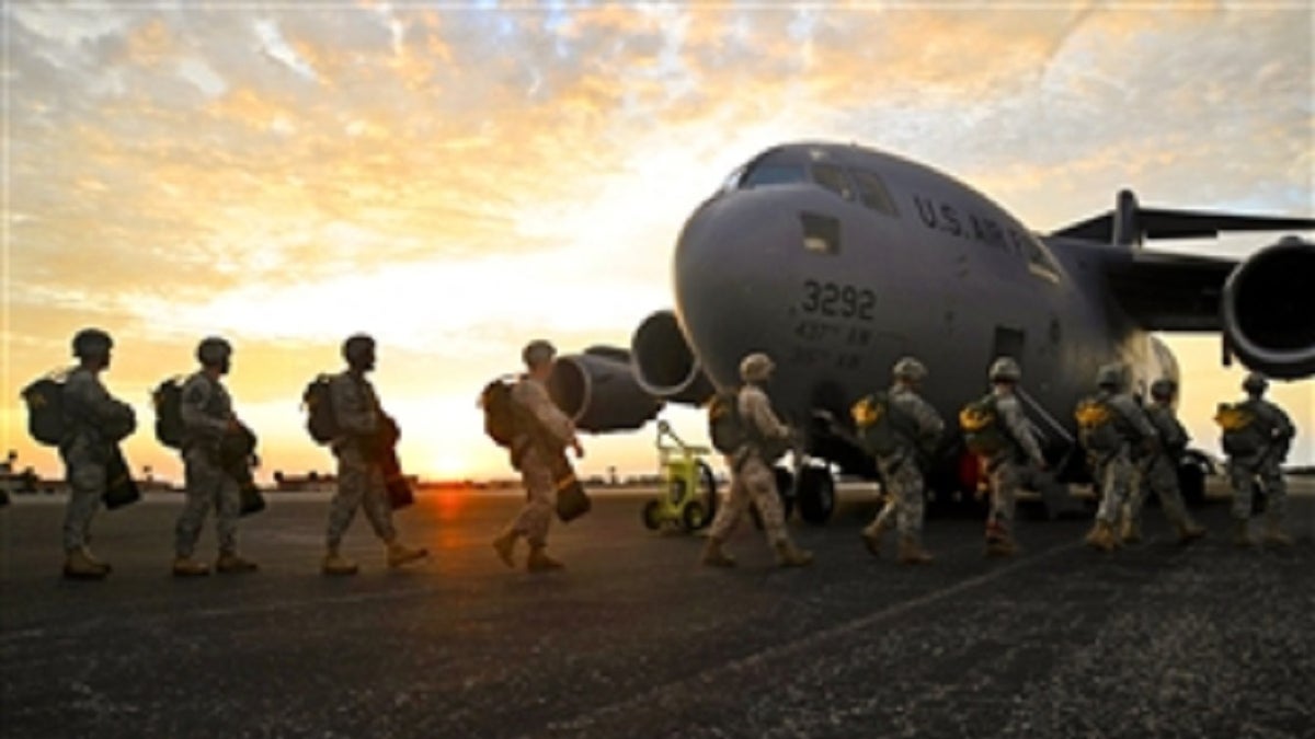 Airmen getting ready to board a large aircraft
