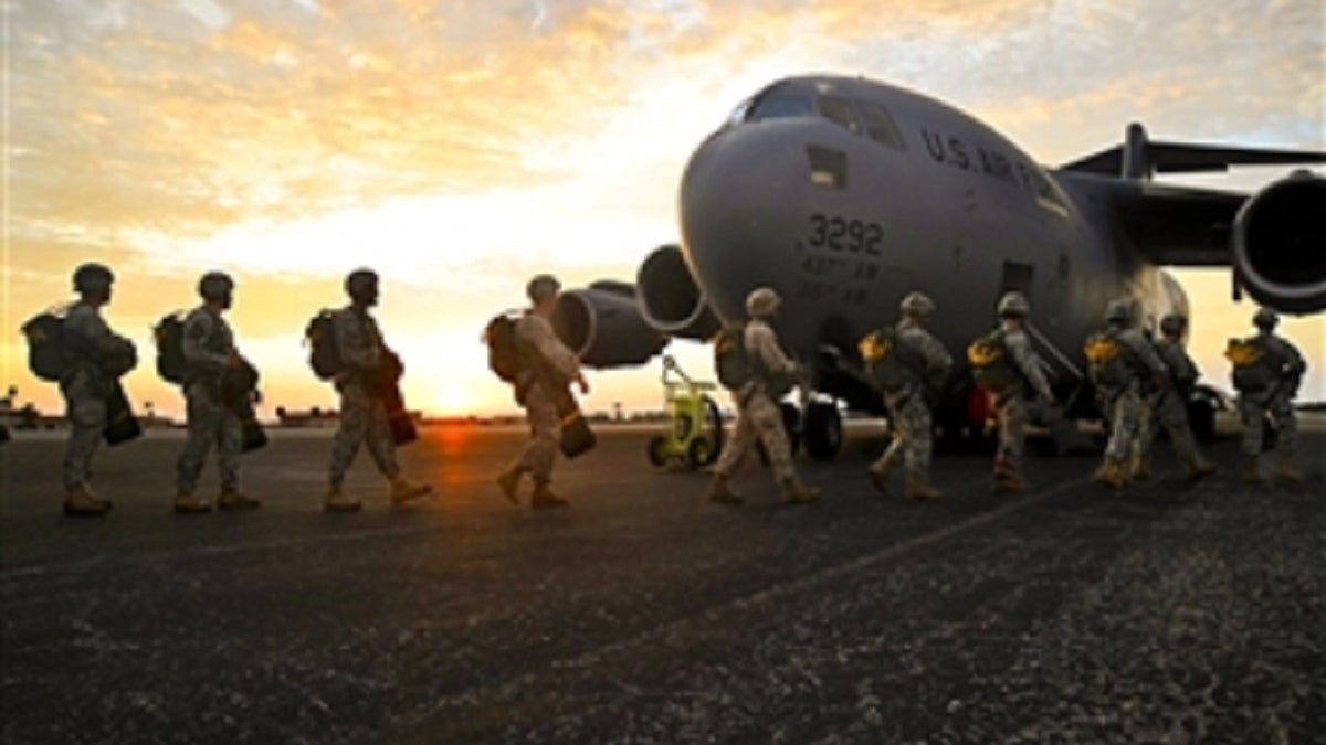 Airmen getting ready to board a large aircraft