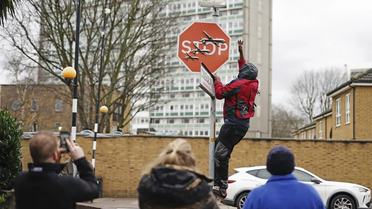London police arrest 2 suspects who allegedly stole Banksy's latest art, a stop sign with 3 drones Banksy Thief