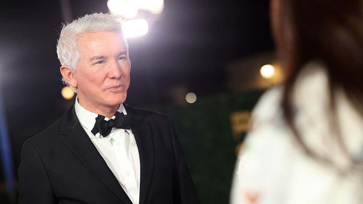 Baz Luhrmann posing on the red carpet