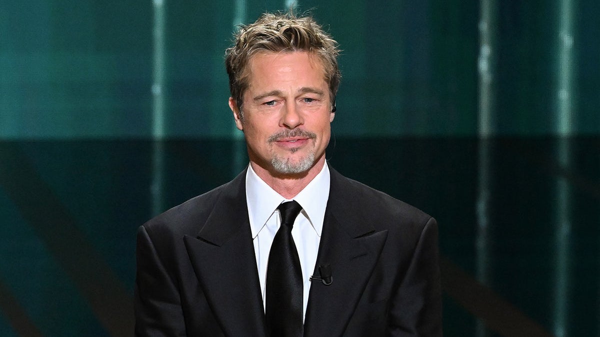 Brad Pitt standing onstage