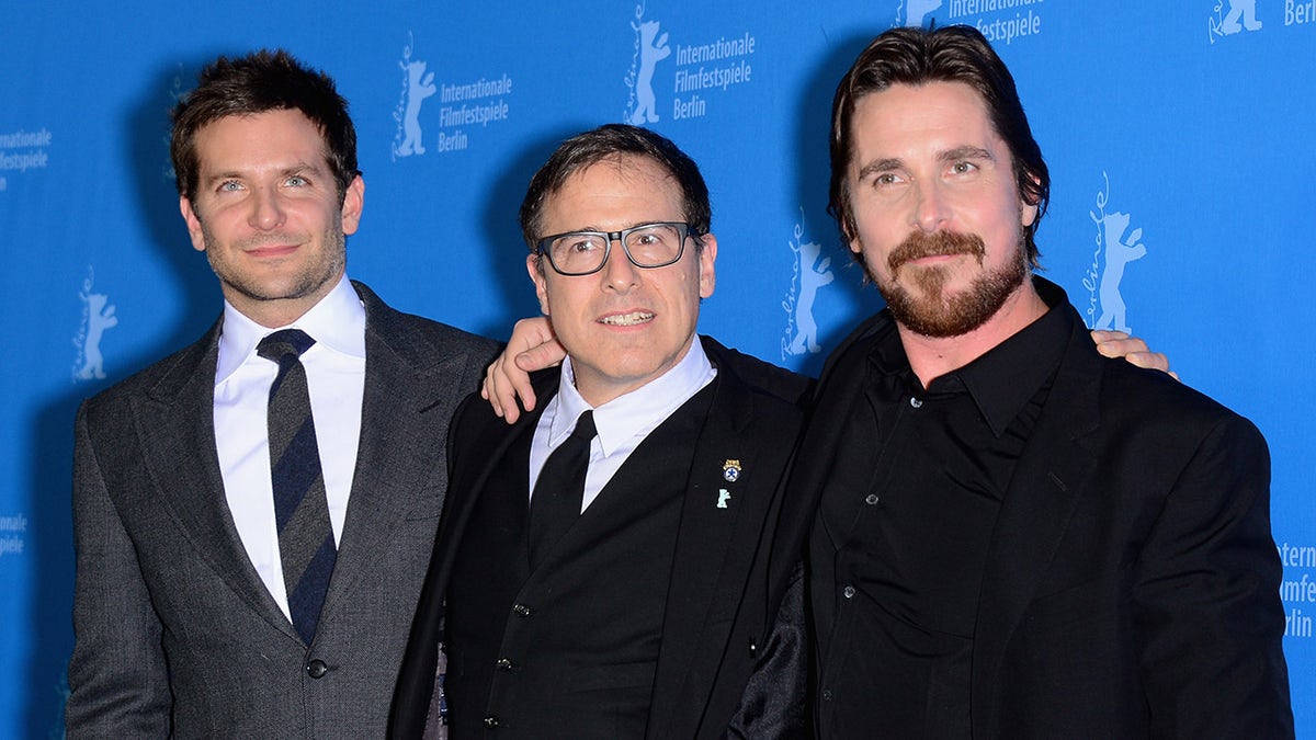 Bardley Cooper, David O. Russell, and Christian Bale pose together