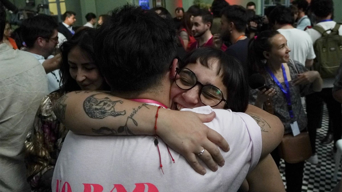 People celebrate after the polls