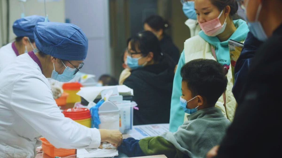A nurse preparing an infusion for a child in China
