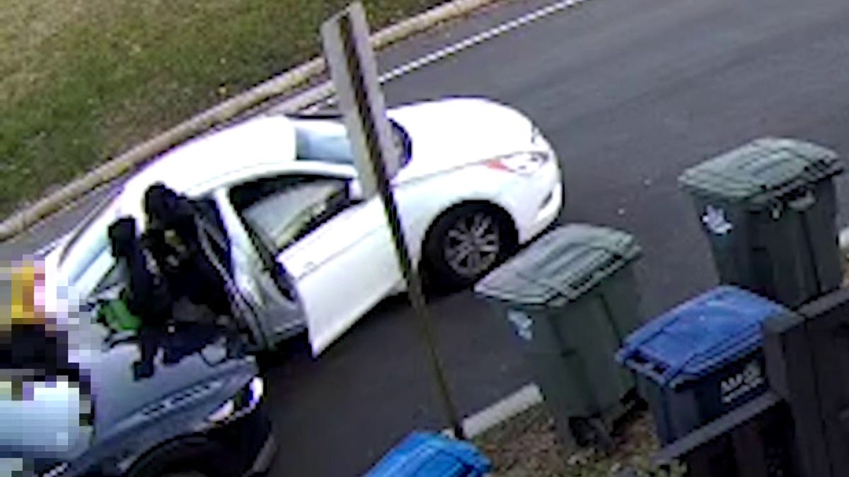 Surveillance footage of white car with suspects in it