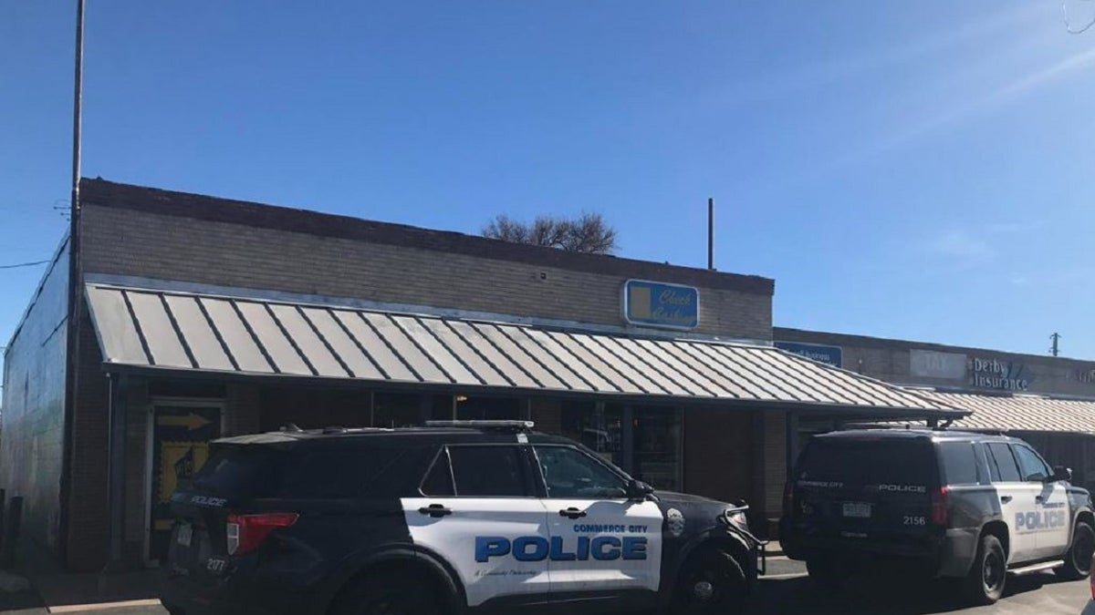 Two Commerce City police vehicles parked outside a business