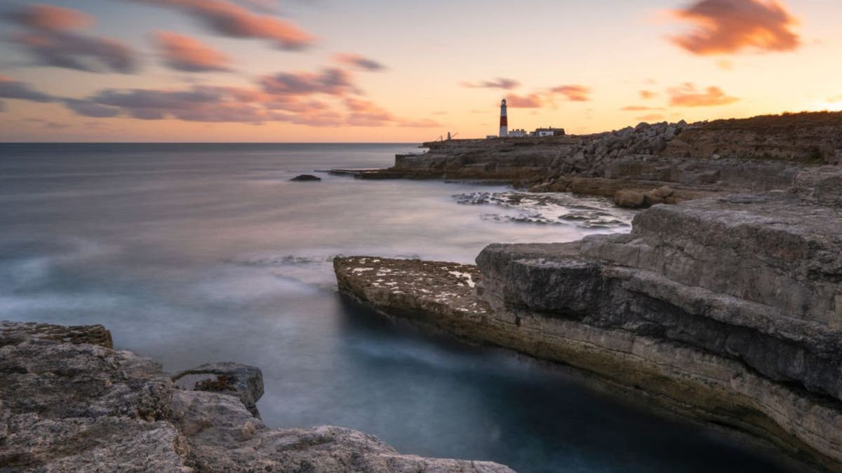 An image of a sunset Sunset over Portland Bill lighthouse in Dorset in the United Kingdom
