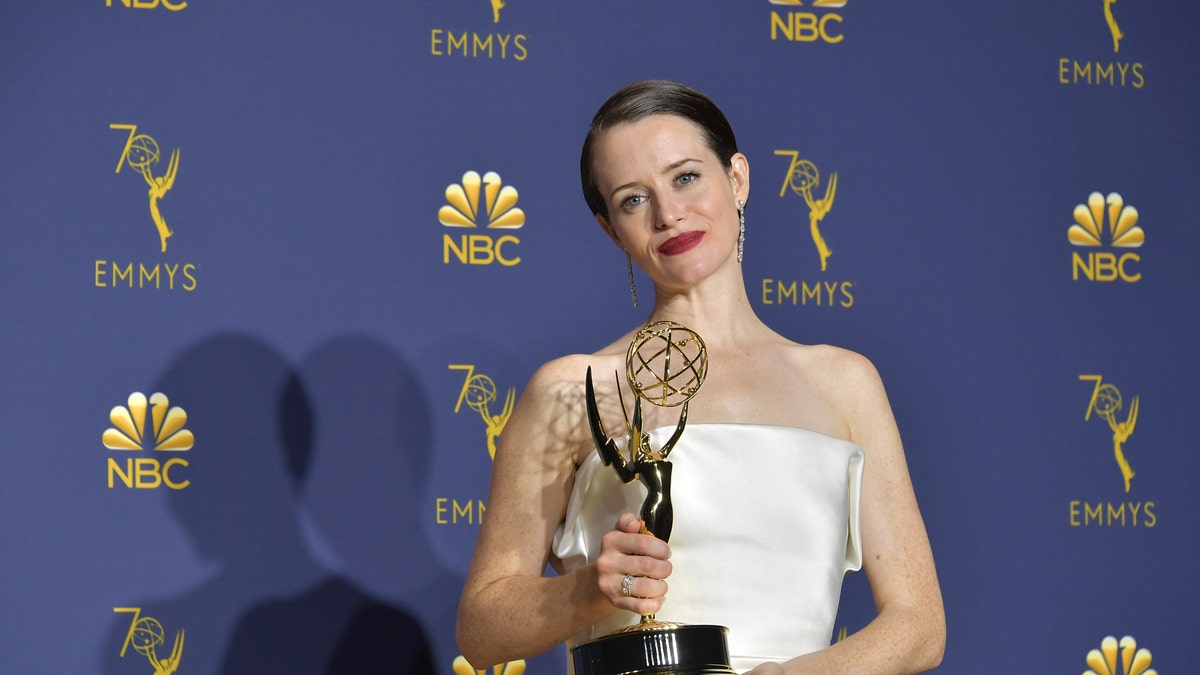 Claire Foy posing with an Emmy award
