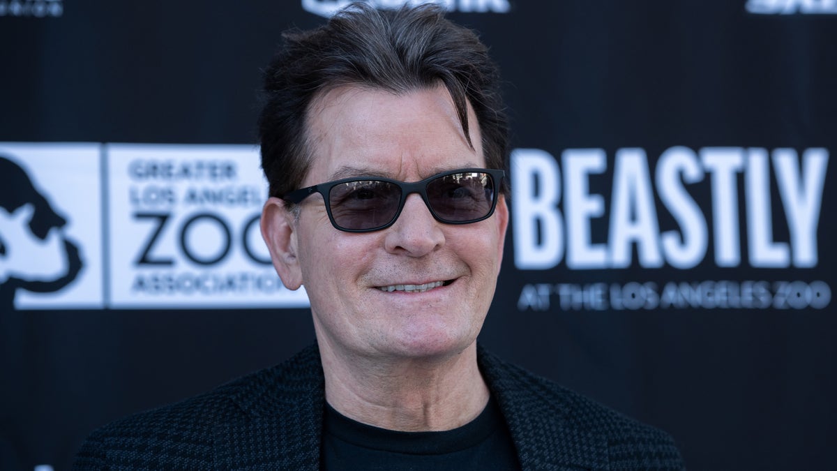 charlie sheen smiling and weairng sunglasses