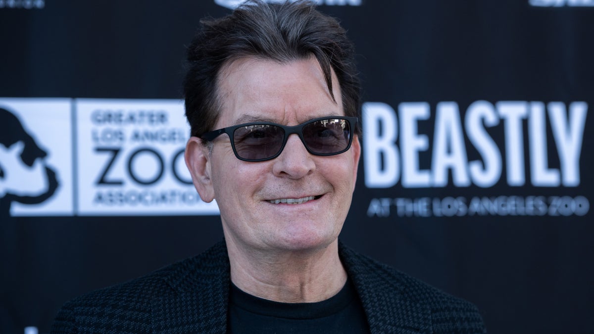 charlie sheen smiling and weairng sunglasses