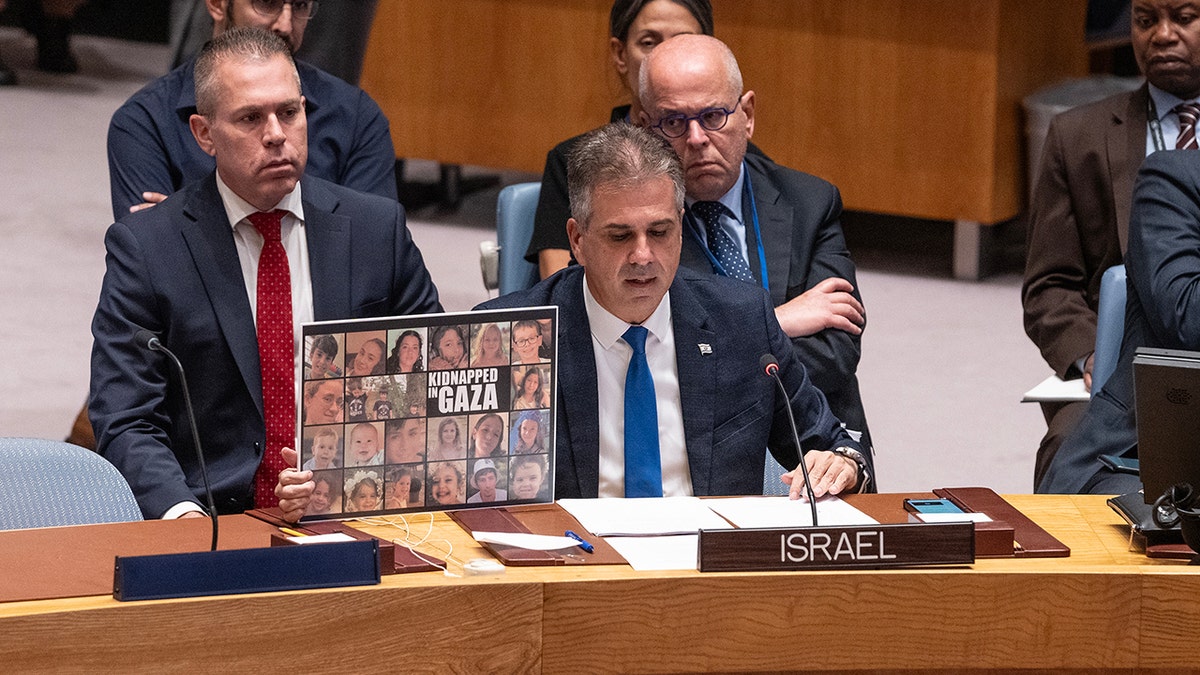 Cohen with a sign of Israeli hostages
