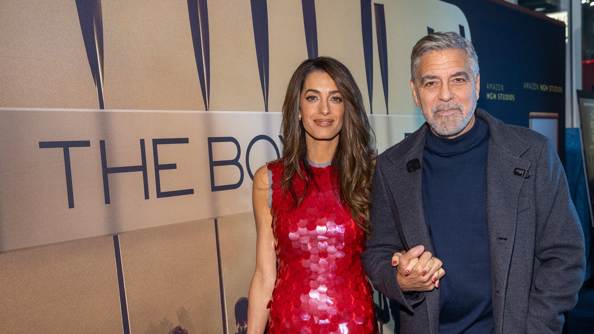 George and Amal Clooney holding hands