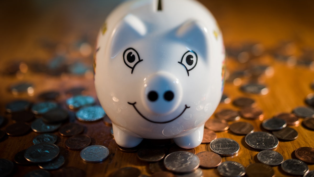 Piggy bank surrounded by coins