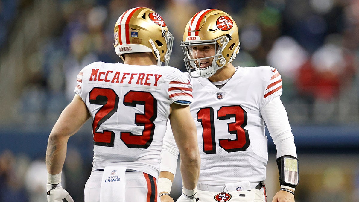 Christian McCaffrey and Brock Purdy celebrate a score