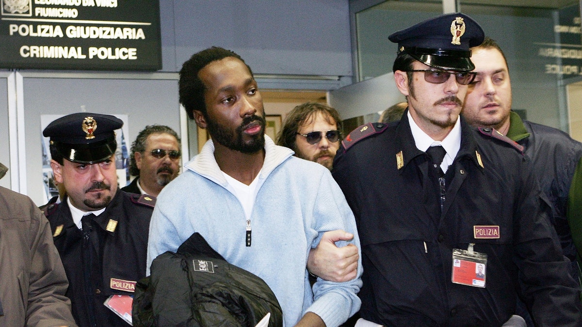 Rudy Guede is escorted by Italian police
